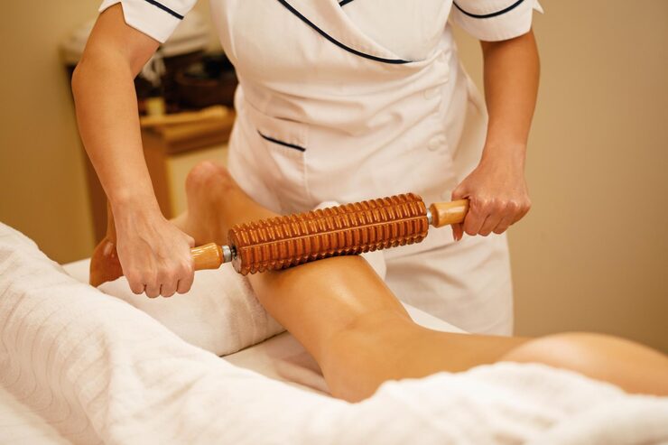 unrecognizable-therapist-performing-maderotherapy-woman-s-legs-massage-treatment-spa_637285-2126